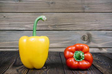 red and yellow pepper on a wooden background