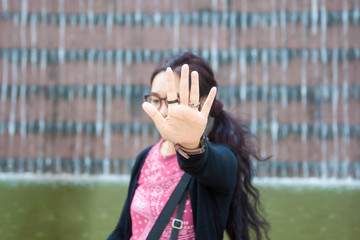 Beautiful celebrity saying no photos. (focus on hand)