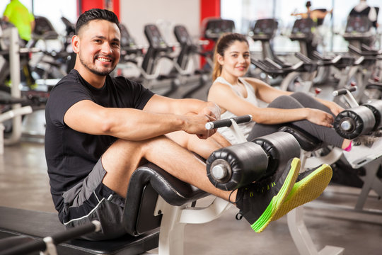Cute couple exercising together in a gym