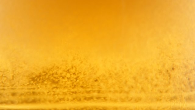 Filling glass with beer while bubbles and foam spreading 4K 2160p UltraHD footage - Golden color of fresh beer bubbles 4K 3840X2160 UHd video 