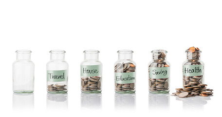 Glass jars with coins, savings concept