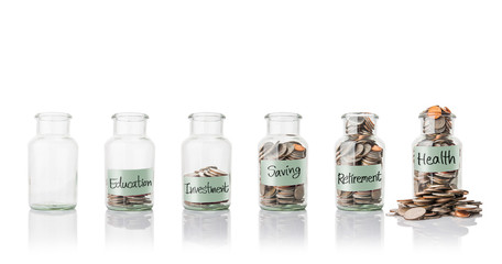 Glass jars with coins, savings concept