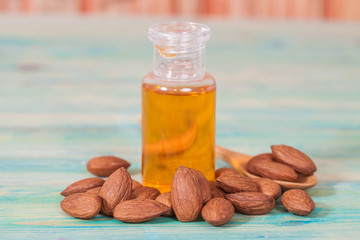 Almonds on wood and oil bottle