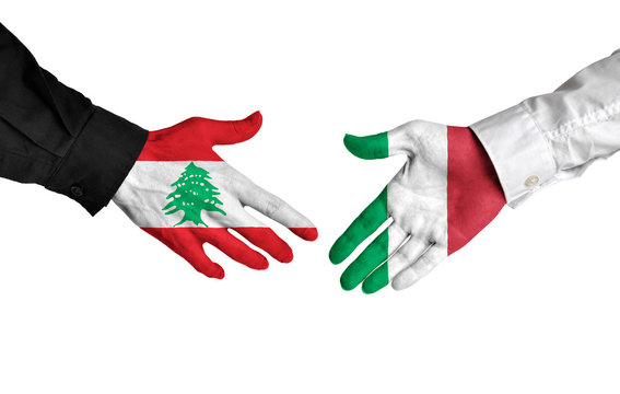 Lebanon and Italy leaders shaking hands on a deal agreement