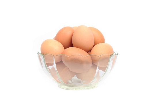 Eggs in glass bowl on white background