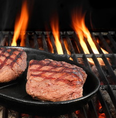 Two Beef Steaks On The Hot BBQ Flaming Grill