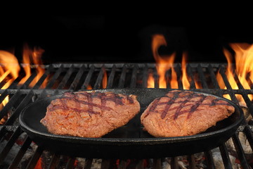 Two Beef Steaks On The Hot BBQ Flaming Grill