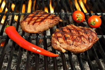 Two Beef Steaks On The Hot BBQ Flaming Grill