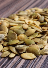 Pumpkin seeds on wooden background