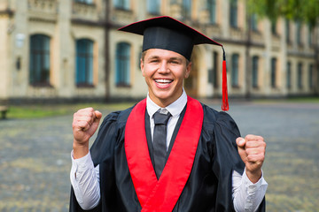 Portrait of a happy graduate male student - graduation concepts