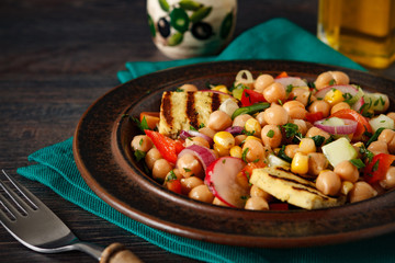 Chickpea salad with raw vegetables and grilled tofu cheese