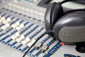 Obraz na płótnie Canvas Headphones On Music Mixer In Studio