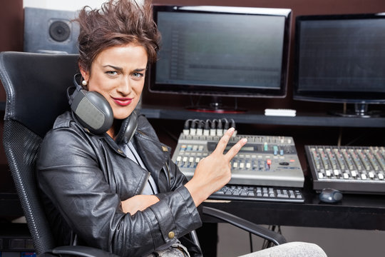 Female Professional Showing Victory Gesture At Mixing Table