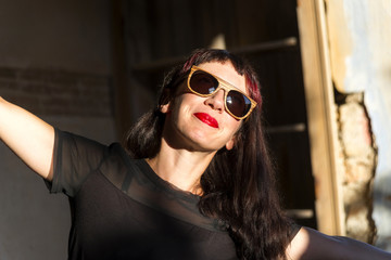 Beautiful young model wearing handmade wooden sunglasses.