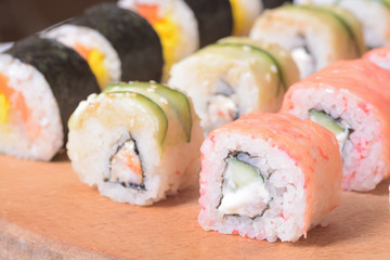 Sushi rolls on wooden background