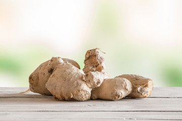 Raw ginger on a wooden table