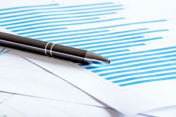 Blue diagram with a pen