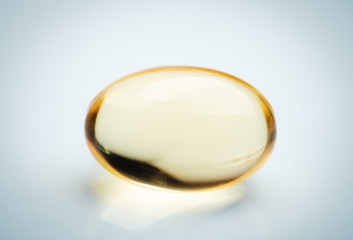 closeup of yellow capsule on white background