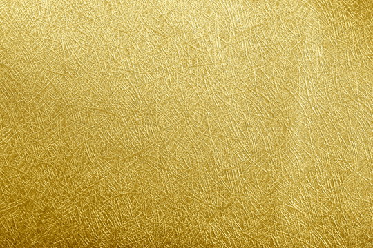Golden paper foil on background texture.