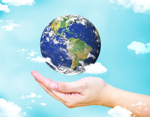 Open female hand with floating  world globe and cloud with light