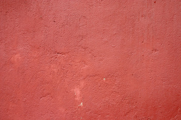 Texture of old red paint on a small area of the surface