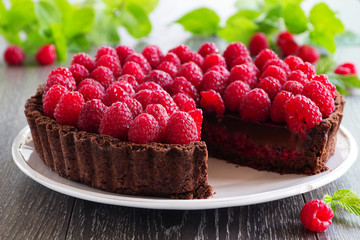 Chocolate tart with fresh raspberries. - obrazy, fototapety, plakaty