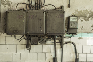 Old electric wires in abandoned building. Grungy interior