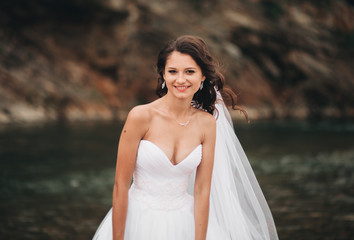 Fototapeta na wymiar Girl, model, bride on a background of the river and mountains. Beauty portrait
