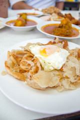 Roti canai with egg and curry