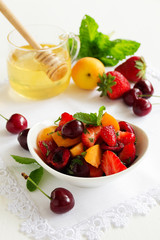 Summer Fruit Salad with strawberries, cherries and peaches in honey dressing.