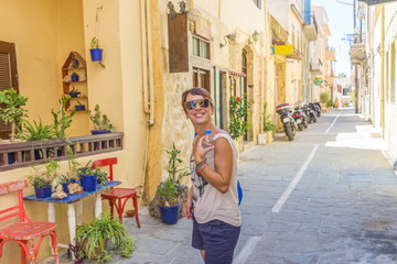 Young pretty girl enjoying the traditional architecture of Crete - 104362706