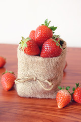 Fresh strawberries in sackcloth bag