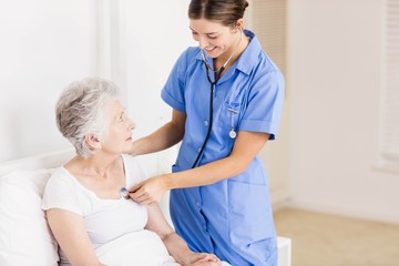 Doctor taking care of suffering senior patient