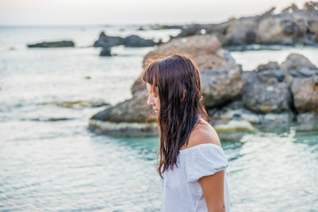 Young brunette girl walking on one of the most beautiful beaches