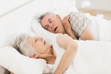 Obraz na płótnie Canvas Awake senior woman in bed