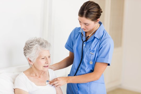 Doctor Taking Care Of Suffering Senior Patient 