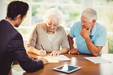 Senior woman signing document