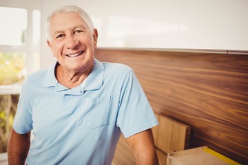 Senior man standing and looking at the camera
