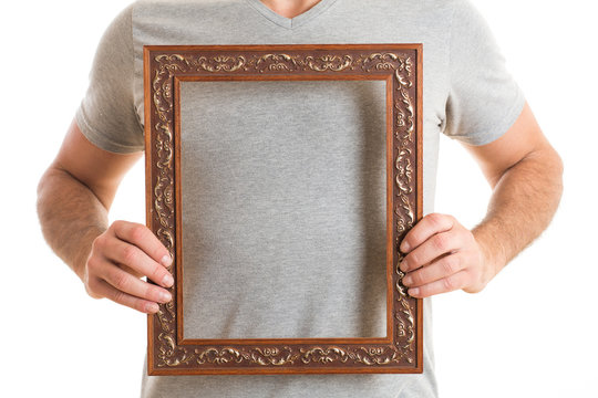 Portrait of a man holding picture frame