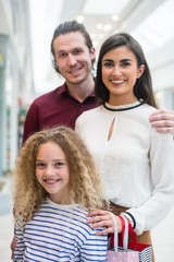 Obraz premium Happy family in shopping mall