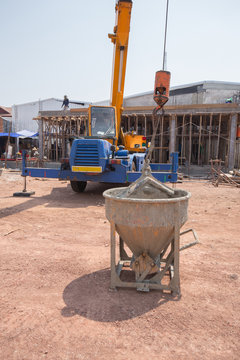 Crane lifting concrete mixer container