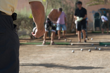 Fototapeta premium Senior playing petanque, balls on the ground