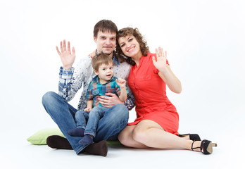 Happy family with child posing on white background