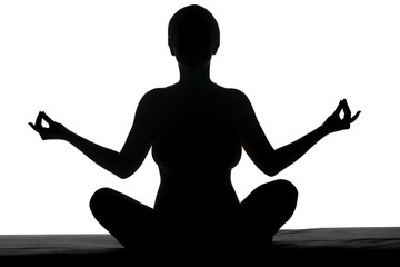 woman meditating in the lotus position. silhouette on a white