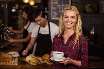 Smiling blonde customer in front of the counter
