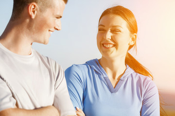 Young couple on beach in sportwear