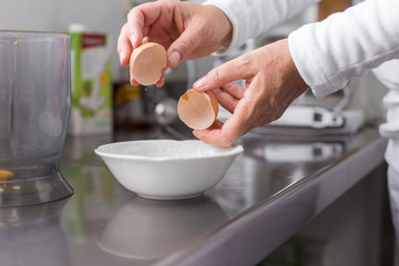 cook cracking an egg