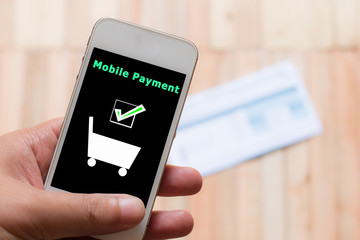 Mobile payment with blur of bill backfround.