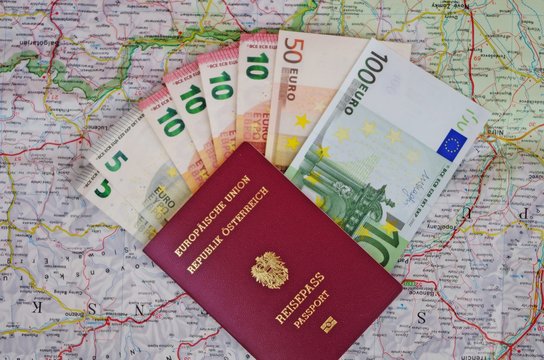euro money with austrian passport on map background