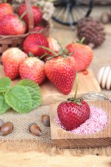 Fresh strawberries red at delicious and plum powder.